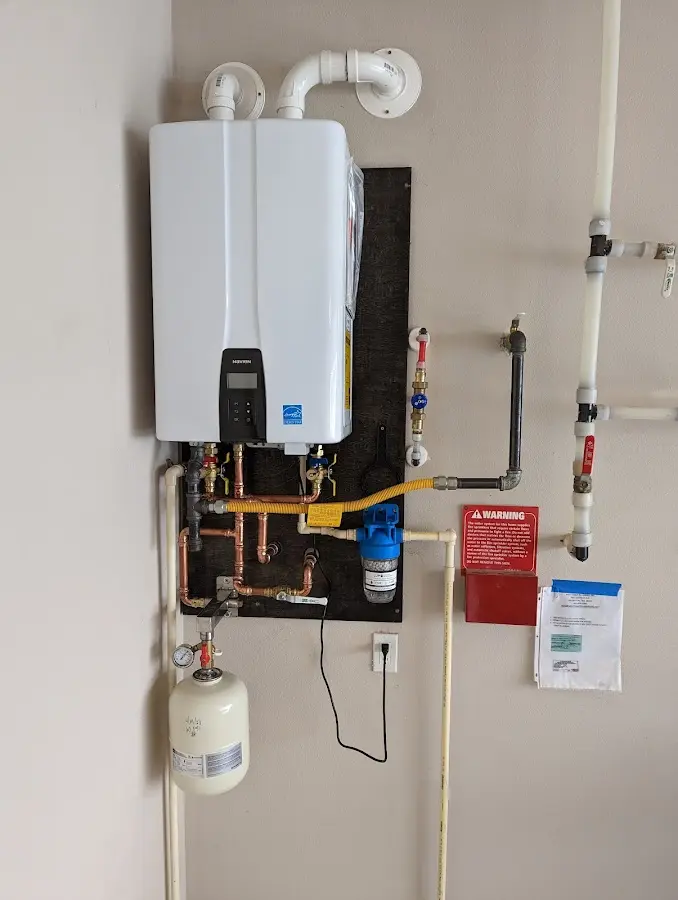 Professional plumber installing copper piping in a Genoa home